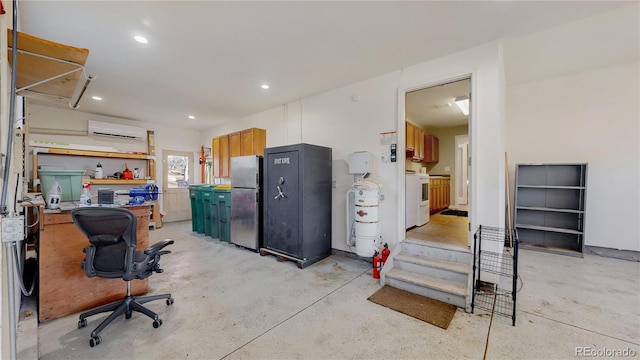 interior space with recessed lighting, a wall unit AC, washer / dryer, and freestanding refrigerator