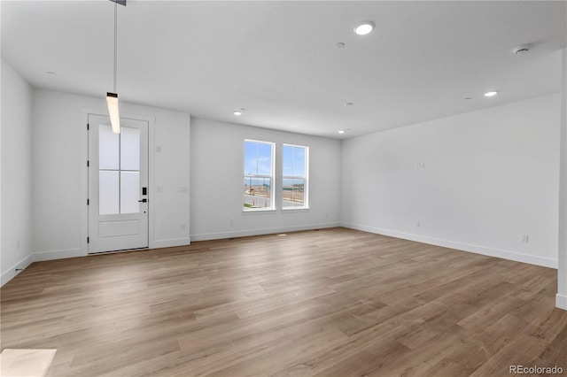 223 Washington St, Erie, CO 80516 - unfurnished living room with recessed lighting, baseboards, and light wood-type flooring