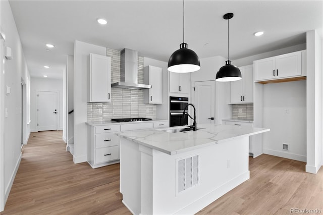 223 Washington St, Erie, CO 80516 - kitchen with wall chimney exhaust hood, a sink, tasteful backsplash, white cabinetry, and black appliances