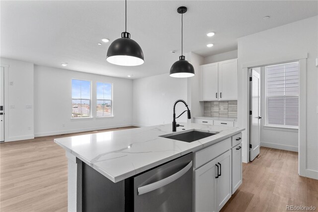 223 Washington St, Erie, CO 80516 - kitchen featuring a sink, stainless steel dishwasher, light wood-type flooring, decorative light fixtures, and recessed lighting