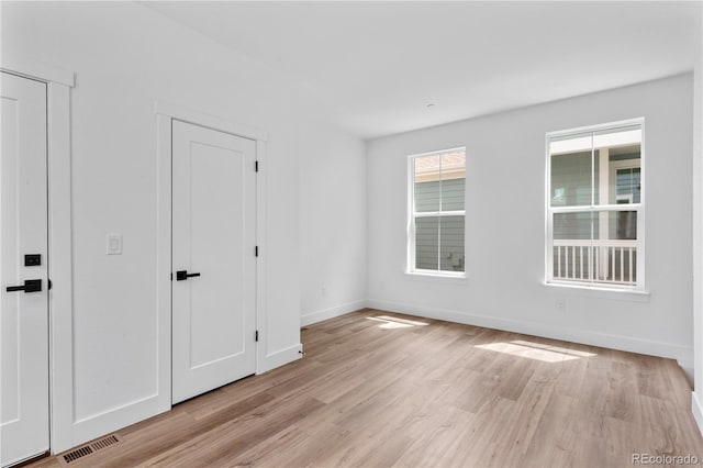 223 Washington St, Erie, CO 80516 - unfurnished bedroom featuring light wood-type flooring and baseboards