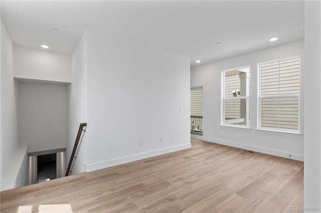 223 Washington St, Erie, CO 80516 - unfurnished living room featuring wood finished floors, baseboards, and recessed lighting