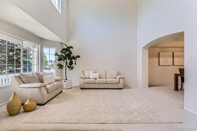 11803 E 114th Pl, Commerce City, CO 80640 - living room with a high ceiling, arched walkways, and carpet floors
