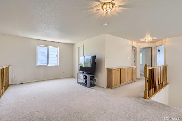 11803 E 114th Pl, Commerce City, CO 80640 - unfurnished living room featuring light colored carpet and a textured ceiling