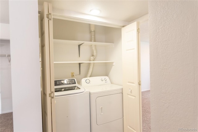 laundry room with washer and clothes dryer and carpet