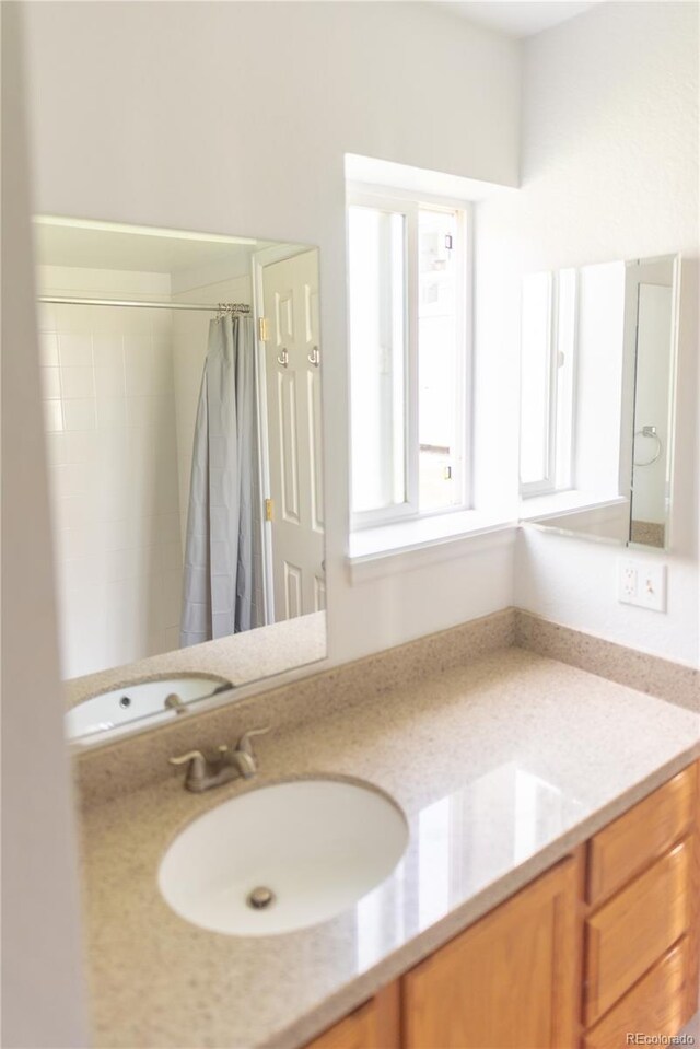 bathroom with vanity and walk in shower