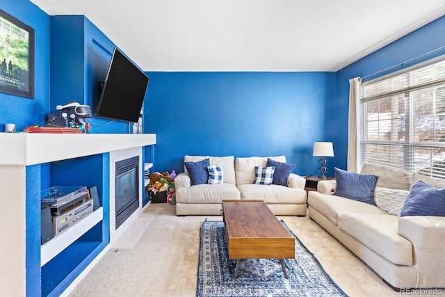 living area featuring light carpet and a tile fireplace