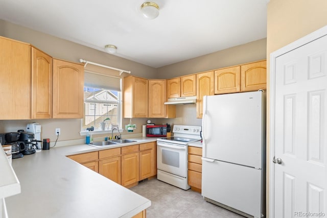 kitchen featuring light countertops, white appliances, a sink, and light brown cabinetry