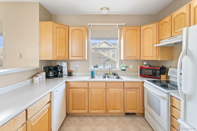 kitchen with light brown cabinets, under cabinet range hood, white appliances, a sink, and light countertops