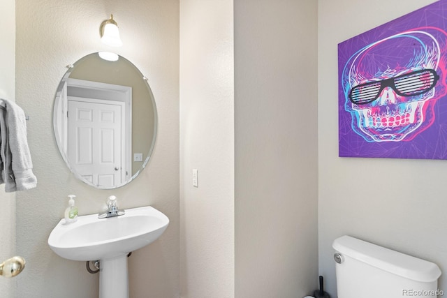 bathroom with a sink and toilet