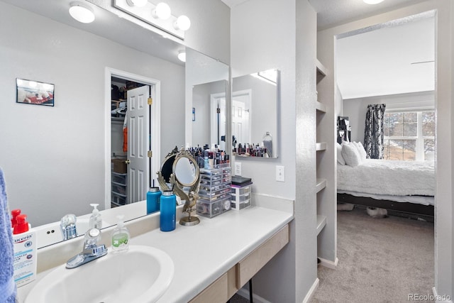 bathroom with vanity and baseboards