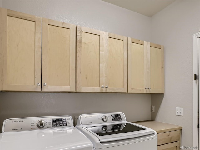 laundry room with cabinet space and washing machine and clothes dryer