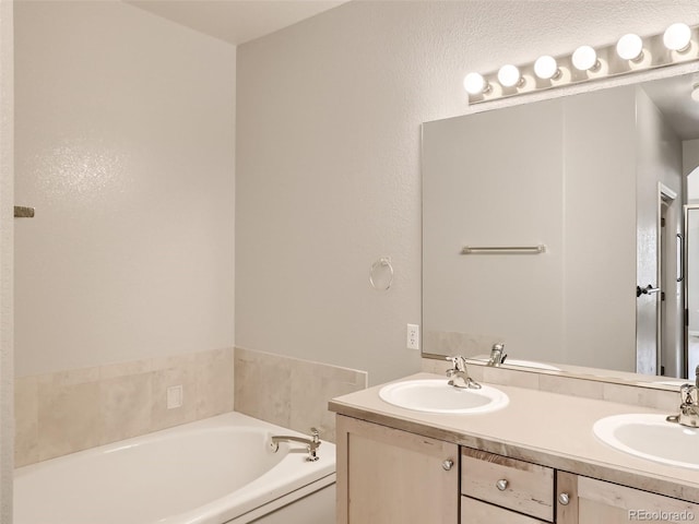 bathroom featuring double vanity, a sink, and a garden tub