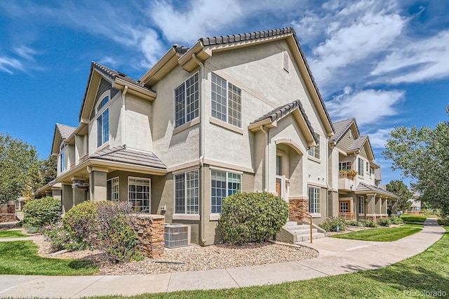 22580 E Ontario Dr Unit 202, Aurora, CO 80016 - view of front of property with stucco siding and cooling unit