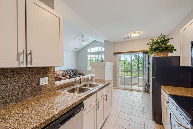 kitchen featuring lofted ceiling, ceiling fan, sink, and white cabinetry