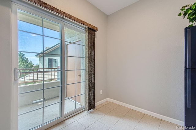 22580 E Ontario Dr Unit 202, Aurora, CO 80016 - doorway to outside with healthy amount of natural light, baseboards, and light tile patterned flooring