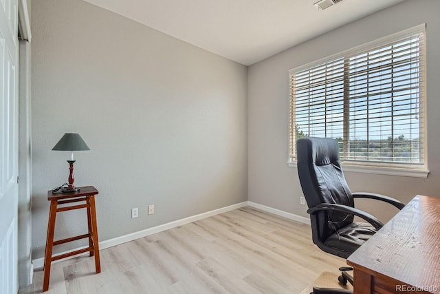 home office featuring light hardwood / wood-style flooring and a wealth of natural light