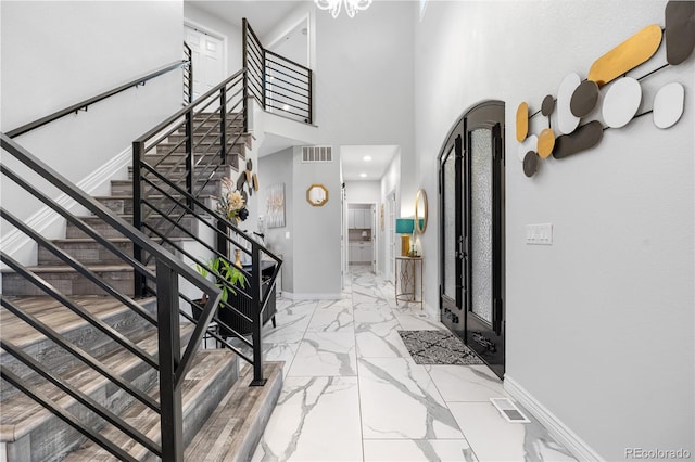 942 S County Road 129th Rd, Bennett, CO 80102 - foyer with visible vents, stairs, marble finish floor, baseboards, and a high ceiling