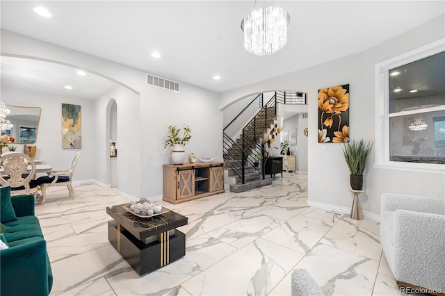 942 S County Road 129th Rd, Bennett, CO 80102 - living area featuring arched walkways, a notable chandelier, visible vents, and stairway