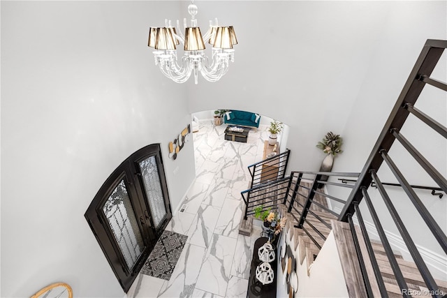 942 S County Road 129th Rd, Bennett, CO 80102 - stairway with a high ceiling, a notable chandelier, and marble finish floor