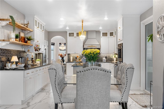 942 S County Road 129th Rd, Bennett, CO 80102 - dining area featuring recessed lighting, arched walkways, a notable chandelier, and marble finish floor