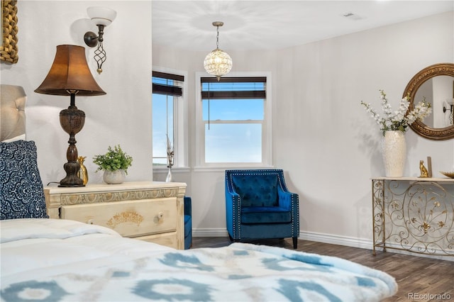 942 S County Road 129th Rd, Bennett, CO 80102 - bedroom featuring an inviting chandelier, baseboards, wood finished floors, and visible vents