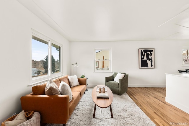 living room featuring light wood finished floors and baseboards