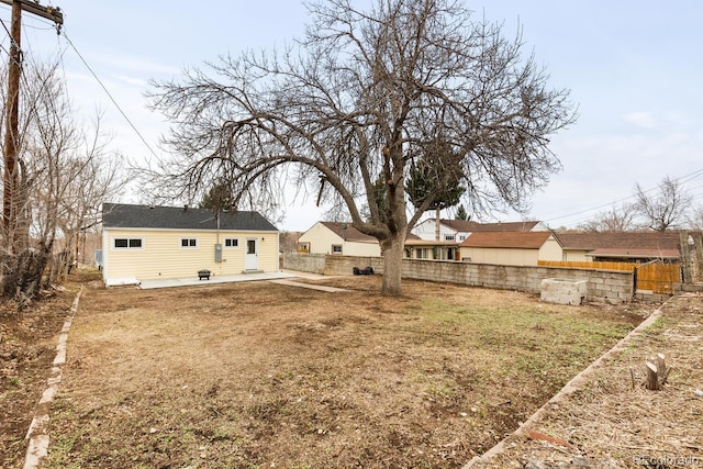 view of yard with a patio area, fence, and an outdoor structure