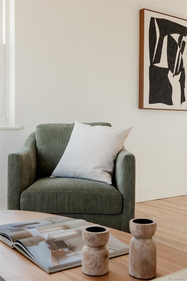 living area with wood finished floors and baseboards