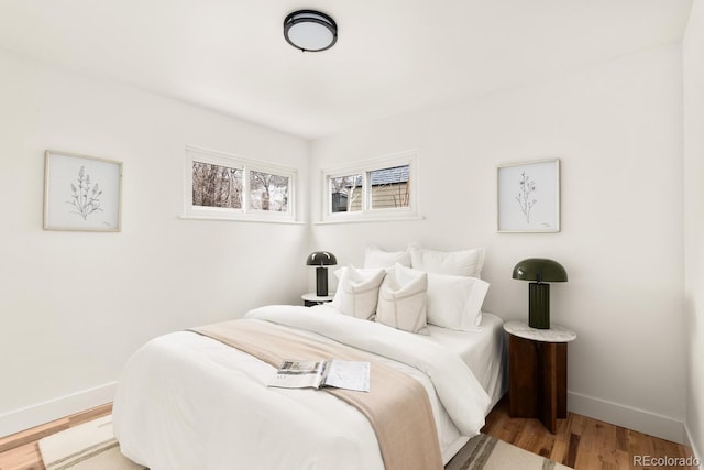 bedroom featuring light wood-style floors and baseboards