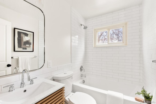 bathroom featuring vanity, toilet, and shower / bathtub combination