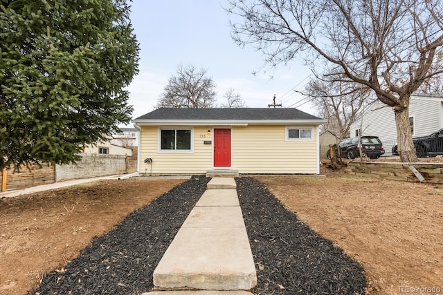 view of front of property featuring a shingled roof and fence