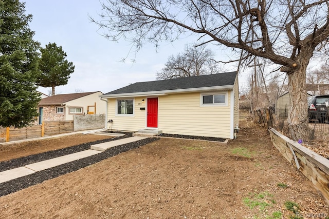 single story home featuring fence