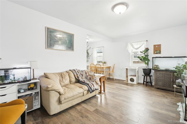 living area featuring baseboards and wood finished floors