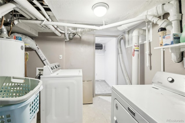 laundry room with laundry area, washer and dryer, and gas water heater