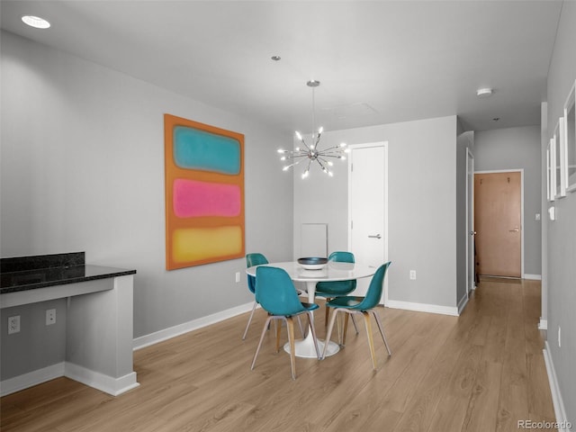 891 14th St Unit 2505, Denver, CO 80202 - dining room featuring light wood-style flooring, a chandelier, and baseboards