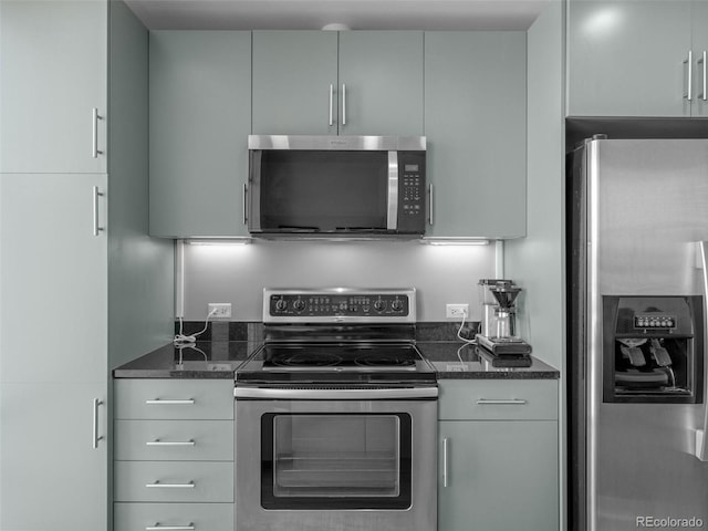 891 14th St Unit 2505, Denver, CO 80202 - kitchen featuring stainless steel appliances, dark stone countertops, and gray cabinets