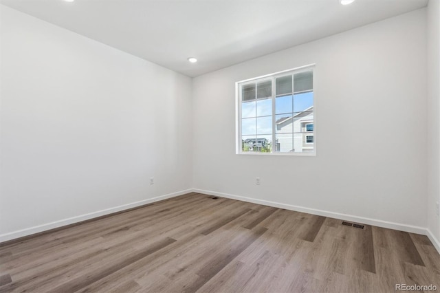 19040 E 96th Pl, Commerce City, CO 80022 - spare room with wood finished floors, baseboards, and recessed lighting