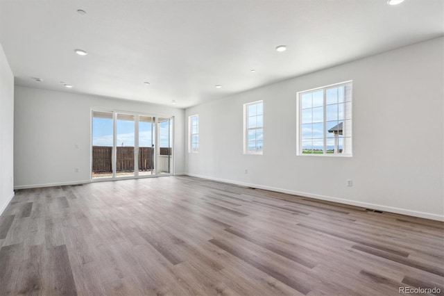 19040 E 96th Pl, Commerce City, CO 80022 - spare room featuring baseboards, recessed lighting, and wood finished floors