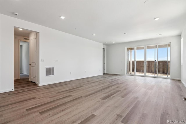 19040 E 96th Pl, Commerce City, CO 80022 - unfurnished room with light wood finished floors, baseboards, and recessed lighting