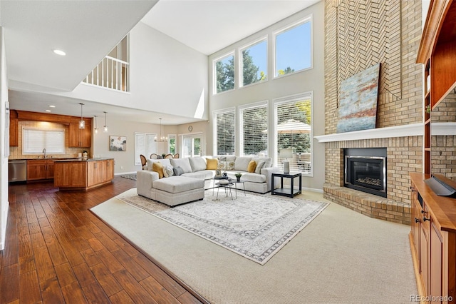 9556 Kemper Dr, Lone Tree, CO 80124 - living room with a high ceiling, dark wood finished floors, and a fireplace