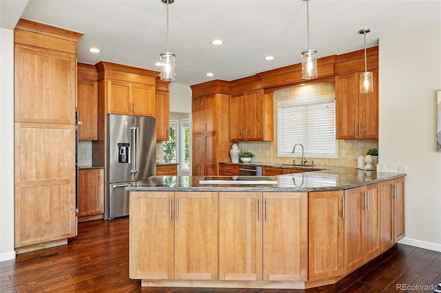 9556 Kemper Dr, Lone Tree, CO 80124 - kitchen featuring appliances with stainless steel finishes, dark wood-style flooring, a peninsula, dark stone counters, and recessed lighting