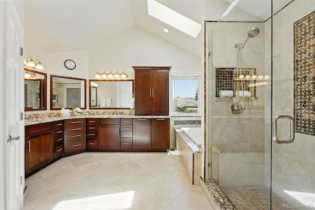 9556 Kemper Dr, Lone Tree, CO 80124 - full bath with a skylight, lofted ceiling, a stall shower, double vanity, and a bath