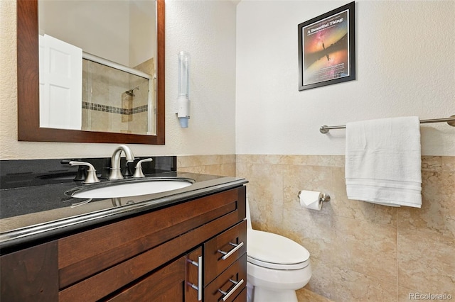 9556 Kemper Dr, Lone Tree, CO 80124 - bathroom with vanity, a tile shower, tile walls, and wainscoting