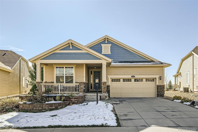 craftsman house featuring central AC unit, a garage, and a porch