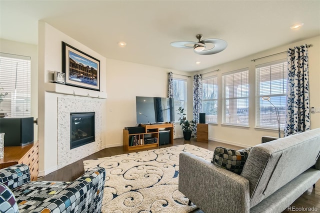 living room with ceiling fan and dark hardwood / wood-style floors