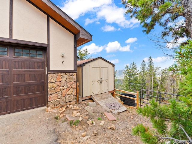 11766 Coal Creek Heights Dr, Golden, CO 80403 - view of shed with fence, cooling unit, and a garage