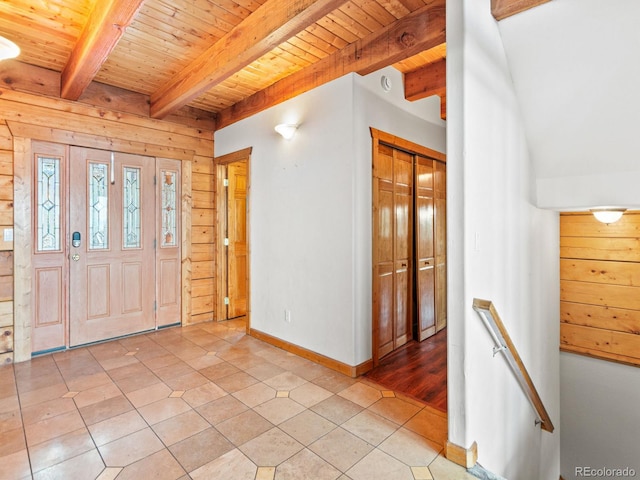 11766 Coal Creek Heights Dr, Golden, CO 80403 - entrance foyer featuring wood ceiling, beam ceiling, light tile patterned floors, baseboards, and wooden walls
