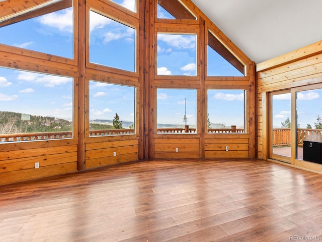 11766 Coal Creek Heights Dr, Golden, CO 80403 - unfurnished sunroom featuring wood finished floors, high vaulted ceiling, and wood walls