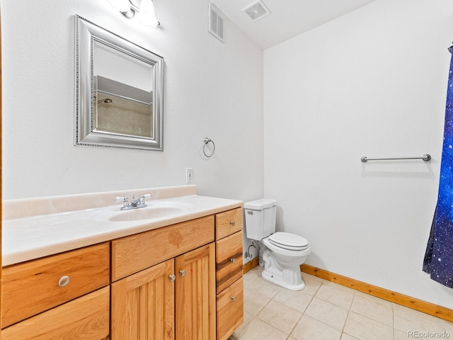 11766 Coal Creek Heights Dr, Golden, CO 80403 - full bathroom featuring vanity, toilet, tile patterned flooring, and baseboards